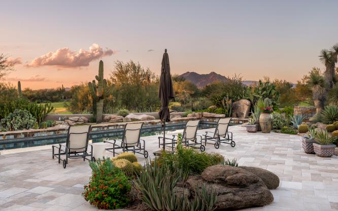 Poolside seating opens to desert, mountain and sunset views.